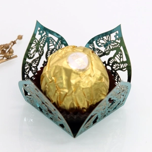 Macro detail of laser-cut butterfly chocolate box with metallic cyan finish