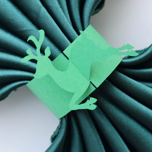 Macro view of a vibrant green reindeer napkin ring made of fine cut cardstock