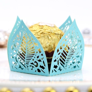 Detailed laser-cut light blue leaf pattern favor box with a gold chocolate inside