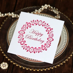 Detail view of a laser-cut Happy Birthday card with elegant floral wreath and pearl accents
