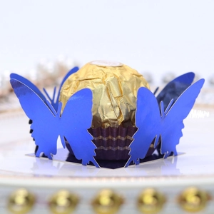 Close-up of laser-cut butterfly chocolate base in navy blue pearlescent paper