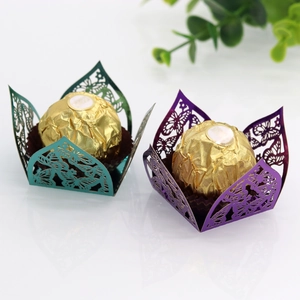 Detail view of laser-cut butterfly cupcake wrappers in shiny green and purple cardstock