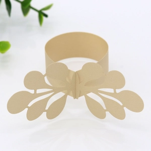 Detail of laser-cut pearl paper napkin ring with champagne gold lace leaf pattern