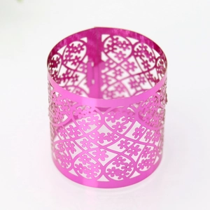 Detail of rose red hollowed floral napkin ring with laser-cut heart and flower patterns