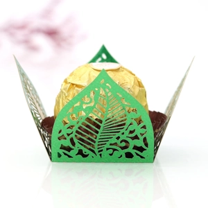 Close-up of green laser-cut hollow leaf paper tray for chocolate and wedding favor candy