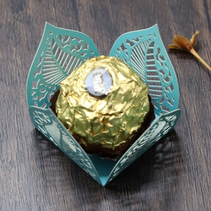 Close-up of laser-cut teal pearlescent paper candy box with leaf pattern detail