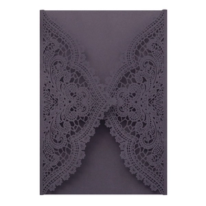 Detailed laser-cut lace pattern on a deep purple wedding invitation card cover