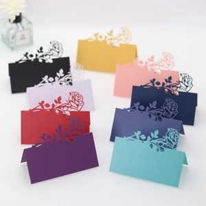 Detailed laser-cut rose design seating cards in various vibrant colors for wedding tables
