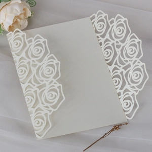 Detail of laser-cut rose floral texture on ivory elegant wedding invitation card