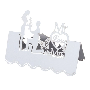 Laser-cut white wedding place card with butterfly heart motif and Mr Mrs silhouettes