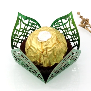 Detail of laser-cut floral patterns on dark green wedding favor box for chocolate