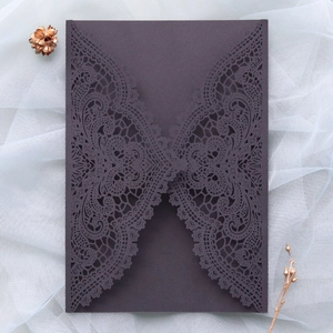 Detailed laser-cut dark purple invitation cover featuring an elegant lace floral pattern
