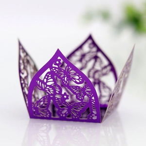 Detail of laser-cut butterfly wedding candy box in purple metallic finish for party decor