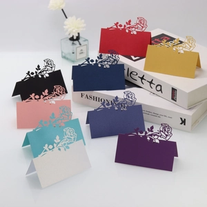 Laser-cut 3D rose place cards in various pearlescent colors for wedding table settings