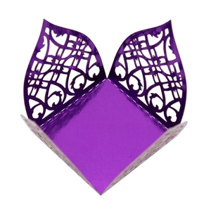 Detail of purple laser-cut candy box featuring intricate floral lace pattern and metallic sheen