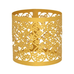 Detail of laser-cut gold pearlescent paper napkin ring with intricate floral lace pattern