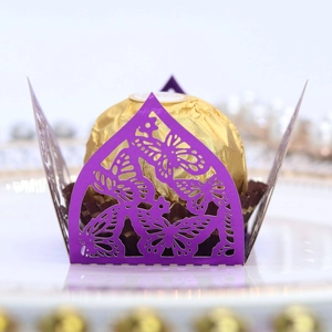 Macro view of laser-cut purple butterfly paper candy box and decorative lace edges