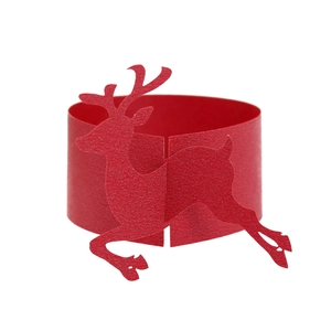 Close-up of red paper napkin ring featuring a laser-cut Christmas reindeer design