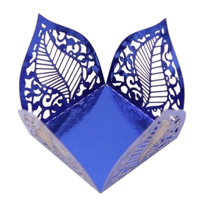 Detailed laser-cut dark blue metallic paper wrapper with intricate leaf vein pattern