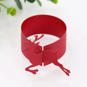 Detailed view of red paper napkin ring with Christmas reindeer cutout design