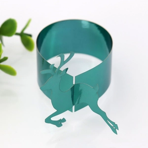 Close-up of teal metallic reindeer napkin ring with festive reindeer cutout design