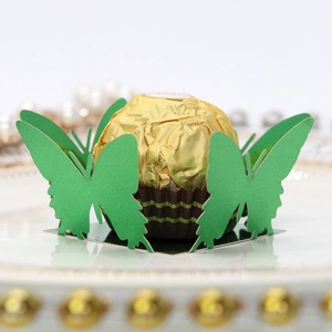 Detail of laser-cut green butterfly candy box decoration for wedding party favors