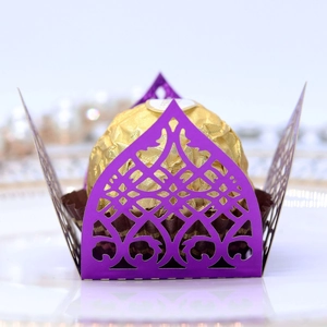 Detail of laser-cut purple paper chocolate wrapper with elegant European floral pattern