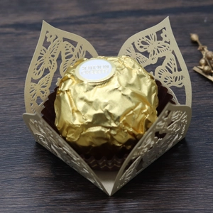 Detail der lasergeschnittenen Schmetterlings-Bonbonschachtel in Gold mit Spitzenmuster