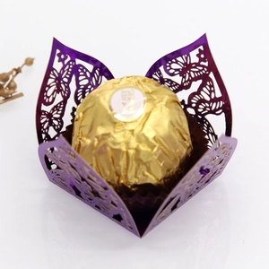 Detail of laser-cut purple butterfly favor box with pearlescent finish for chocolates