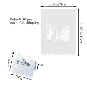 Detail of laser cut white wedding place cards with Mr & Mrs and butterfly patterns
