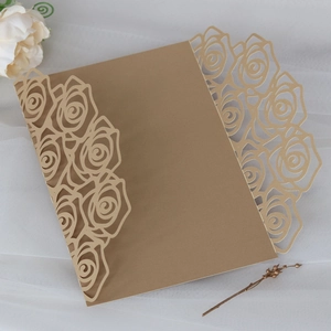 Detail view of laser-cut rose hollow design on gold floral wedding invitation cover