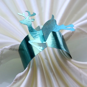 Macro view of blue reindeer napkin ring with reflective metallic finish for Christmas table