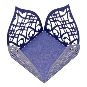 Macro view of purple laser-cut pearl paper candy box with intricate floral hollow design