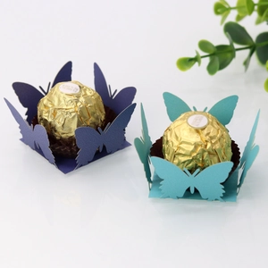 Intricate laser-cut butterfly chocolate wrappers in deep purple and lake blue cardstock