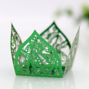 Detail of laser-cut green butterfly pattern on a hollow chocolate favor gift box