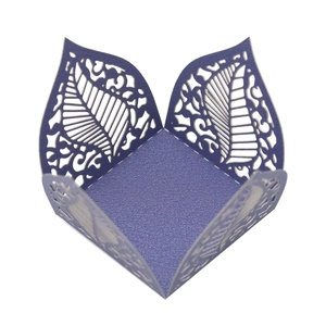 Detailed macro view of laser-cut purple hollow leaf pattern on pearlescent paper candy box