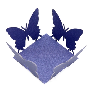Macro detail of laser-cut purple butterfly favor box with elegant pearl paper texture