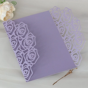Detailed laser-cut purple rose floral invitation card on elegant white tulle background