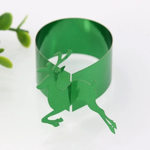 Close-up of a glossy green reindeer paper napkin ring with a reflective mirror finish