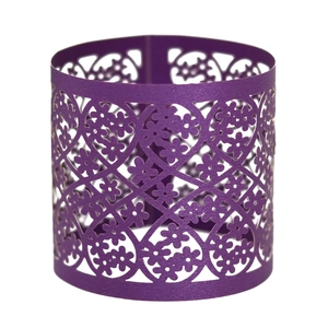 Macro shot of purple laser-cut paper napkin ring with intricate floral lace pattern
