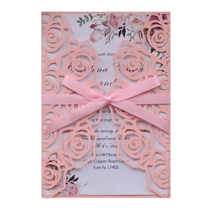 Elegant laser-cut wedding invitation with pink rose pattern, satin bow and inner card