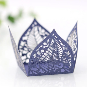 Macro detail of laser-cut purple paper candy box with intricate leaf-shaped vein patterns