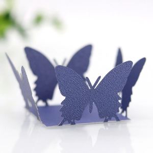 Macro detail of deep purple laser-cut butterfly gift box with pearlescent texture