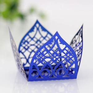 Detailed laser-cut dark blue paper cupcake wrapper with intricate Arabic geometric pattern