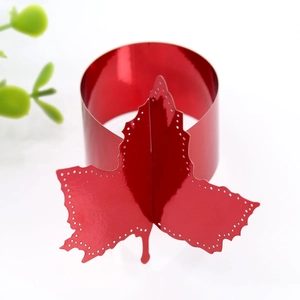 Detailed view of red maple leaf napkin ring with laser-cut edges and metallic finish