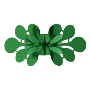 Macro detail of metallic green leaf-shaped napkin ring with intricate laser-cut design