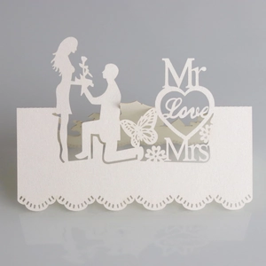 Laser-cut white wedding place card featuring a romantic silhouette and pearl texture