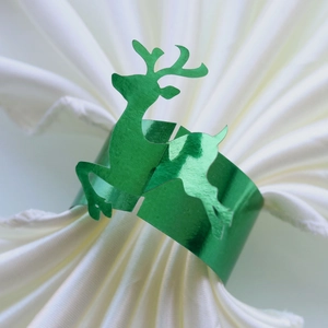 Detail of green mirror finish reindeer napkin ring with festive metallic reflection