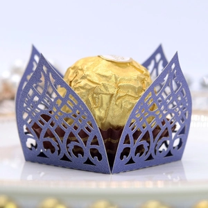 Close-up of purple laser-cut pearl paper chocolate wrapper with elegant hollow lace patterns