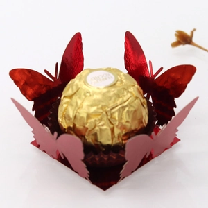 Detail of laser-cut red butterfly candy box with metallic finish and lace edges
